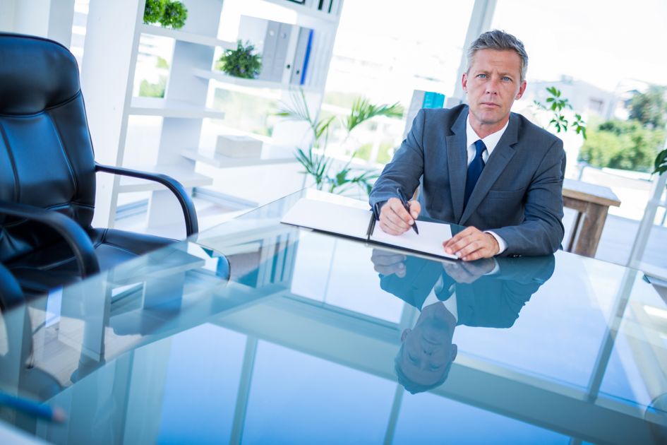 Professional workspace with documents and laptop showing broker resources